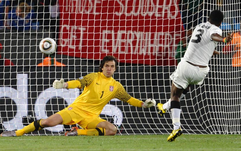 Asamoah Gyan slots home a late penalty to give Ghana a 1-0 victory over ten-man Serbia.